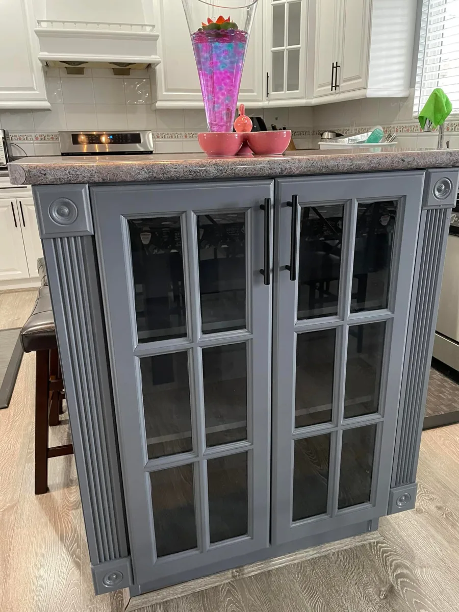 Grey painted kitchen island cabinets with glass front doors by Johhan Painting