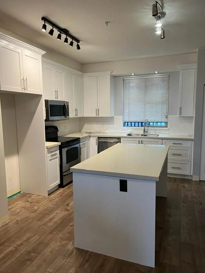 White painted kitchen cabinets and island by Johhan Painting