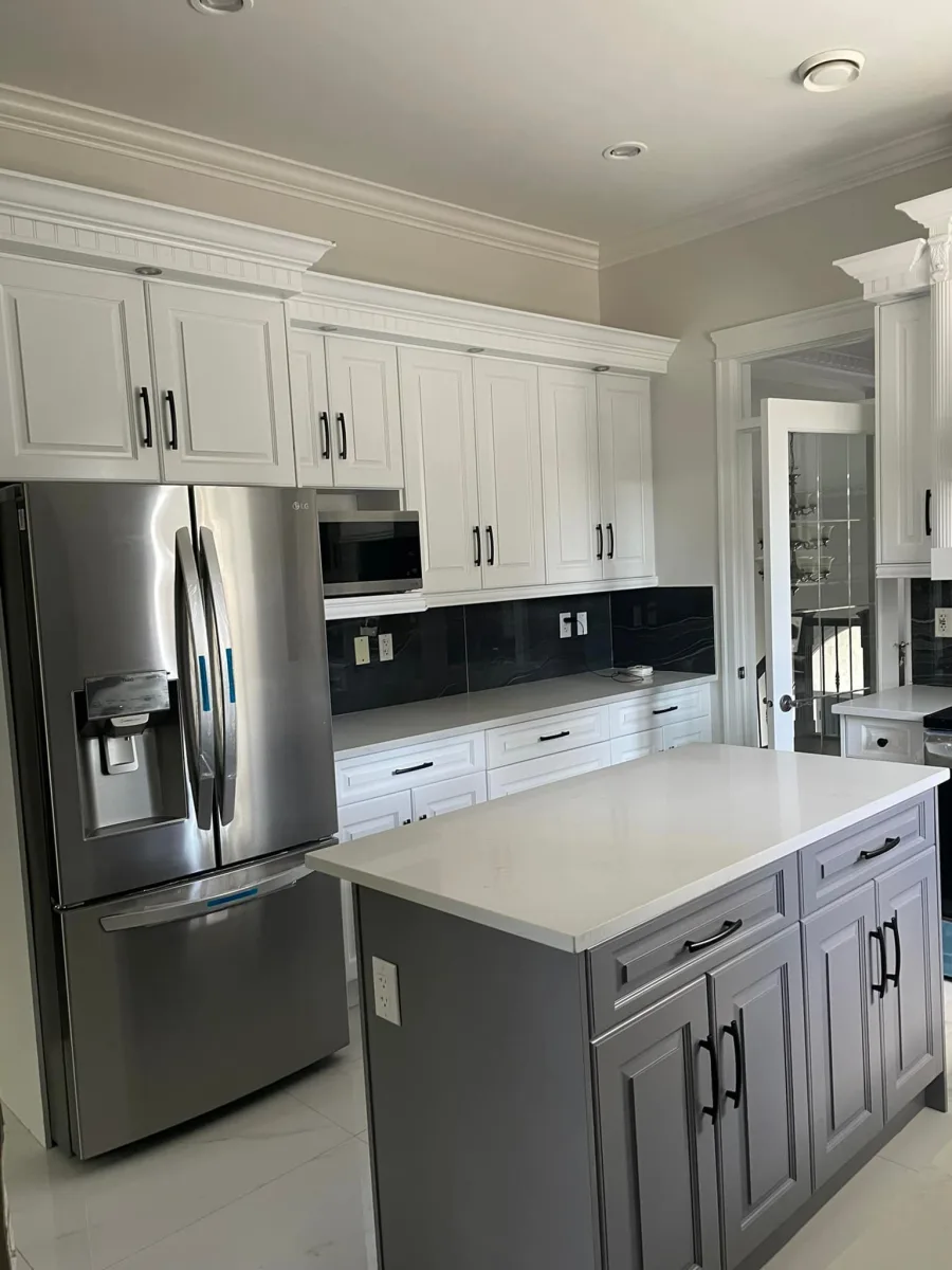 White painted kitchen cabinets with a grey painted island by Johhan Painting